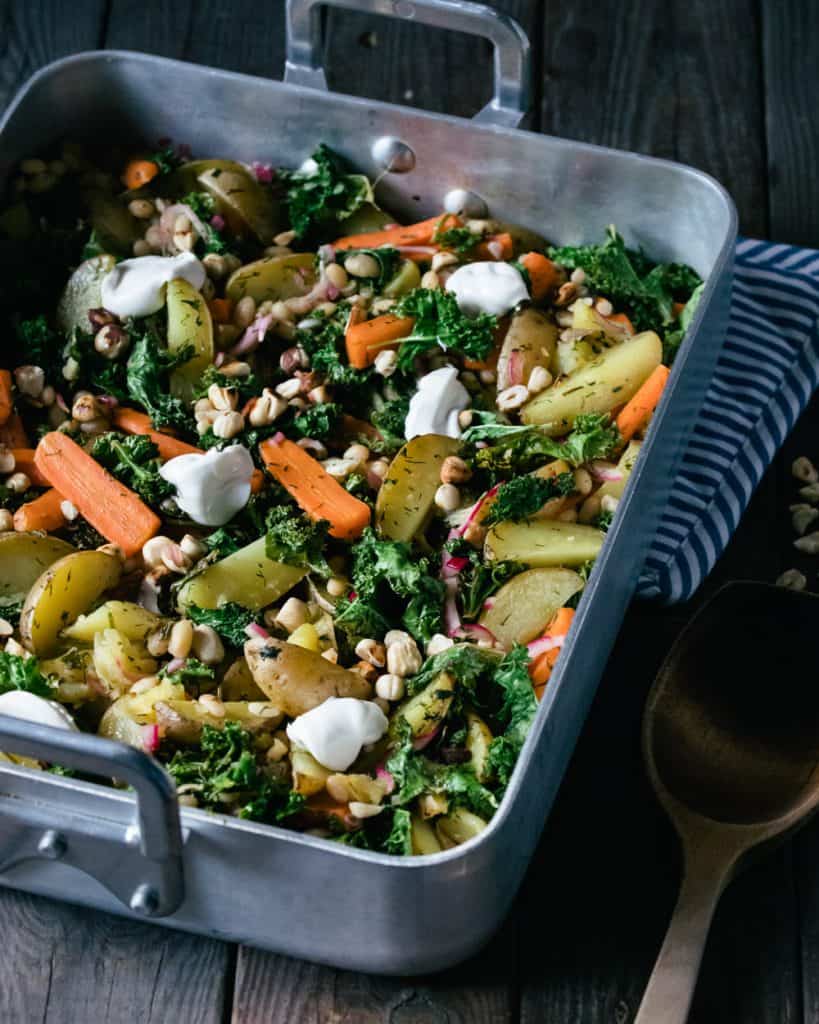 roasted root vegetables in a roasting pan on a table