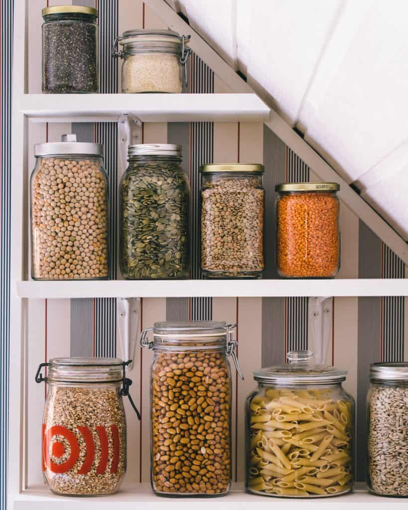Jars of pantry items on a shelf.