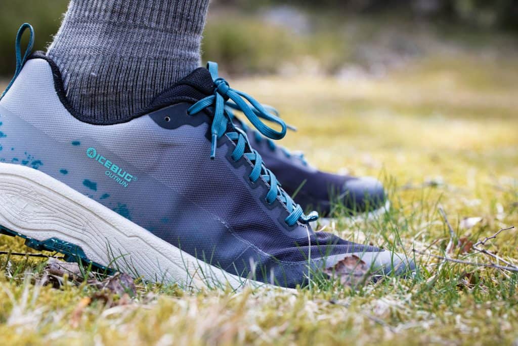 Close up of running shoes in the grass.