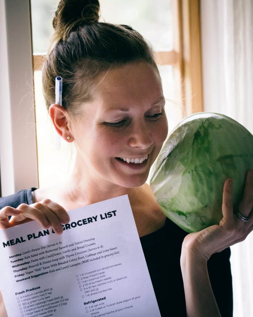 Women holding a cabbage head.