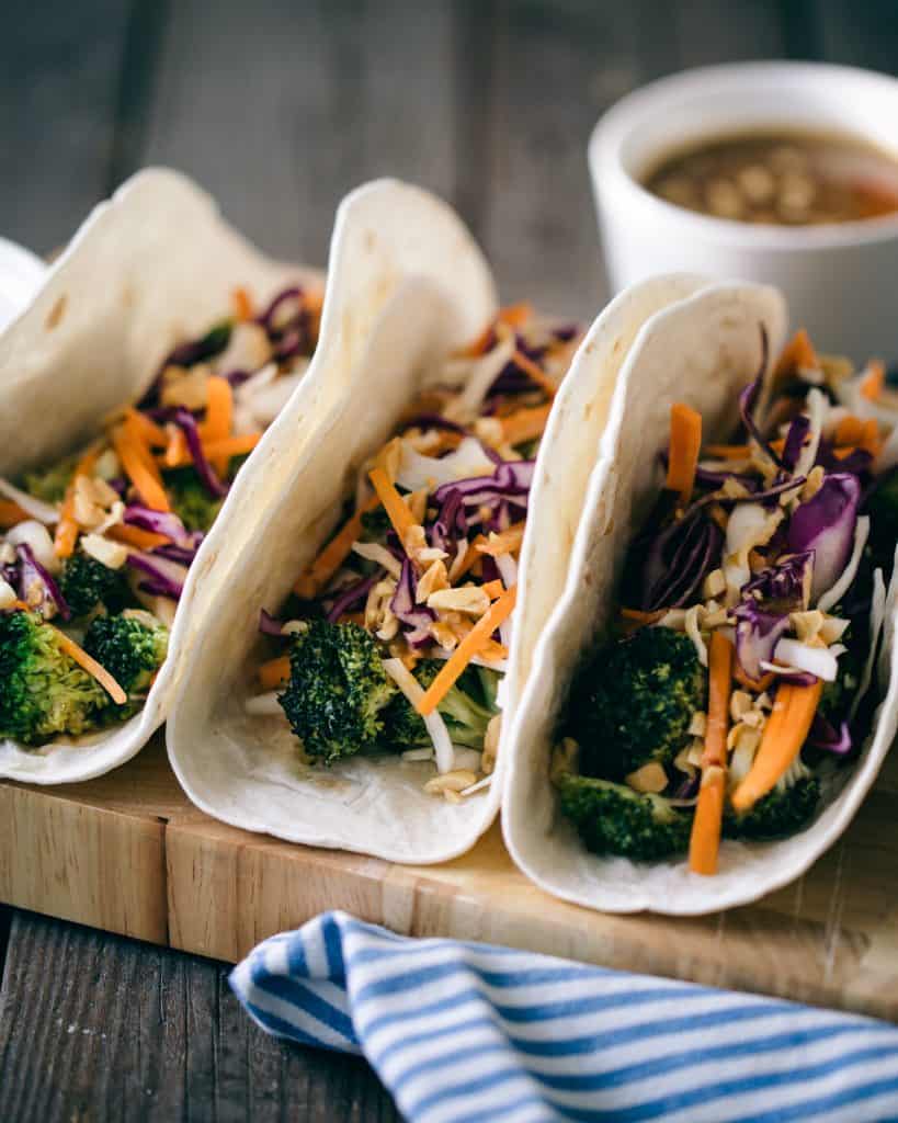 Three tacos with broccoli.